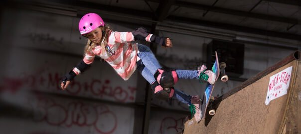 Girl skateboarding down a ramp